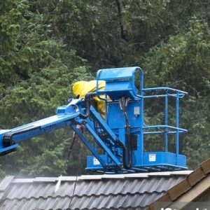 "Worker power washing the roof, getting the moss off and cleaning up the tiles.Home maintenance photos here..."